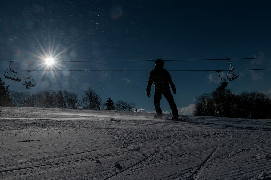 Silhouette snowboarder coming down slope Photograph by Dan Friend