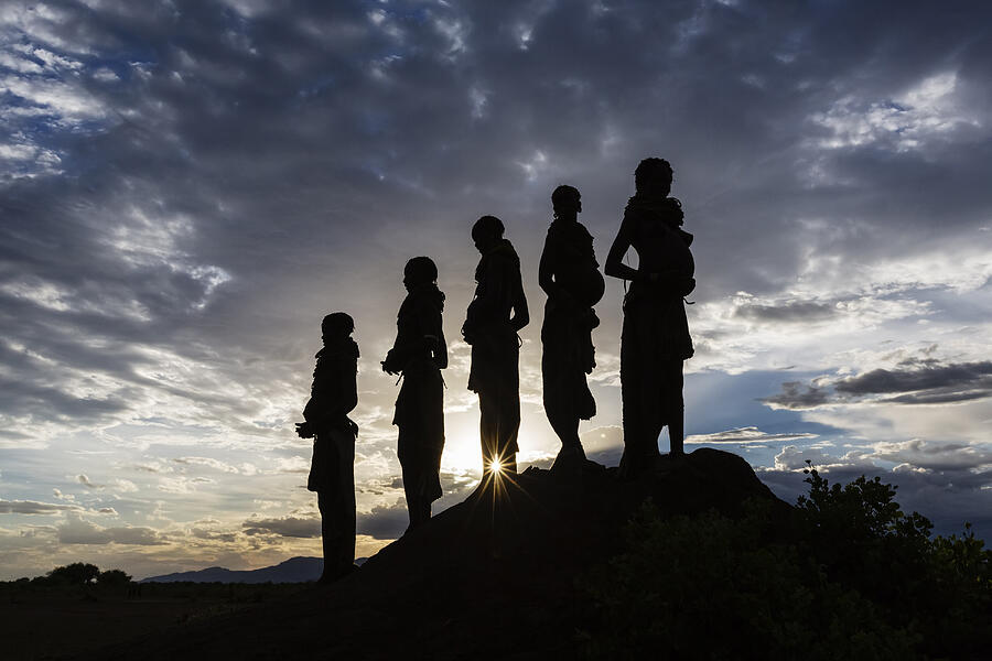 Silhouettes of pregnant woman under cloudy sky at sunset, Nyangaton, Ethiopia Photograph by Jeremy Woodhouse
