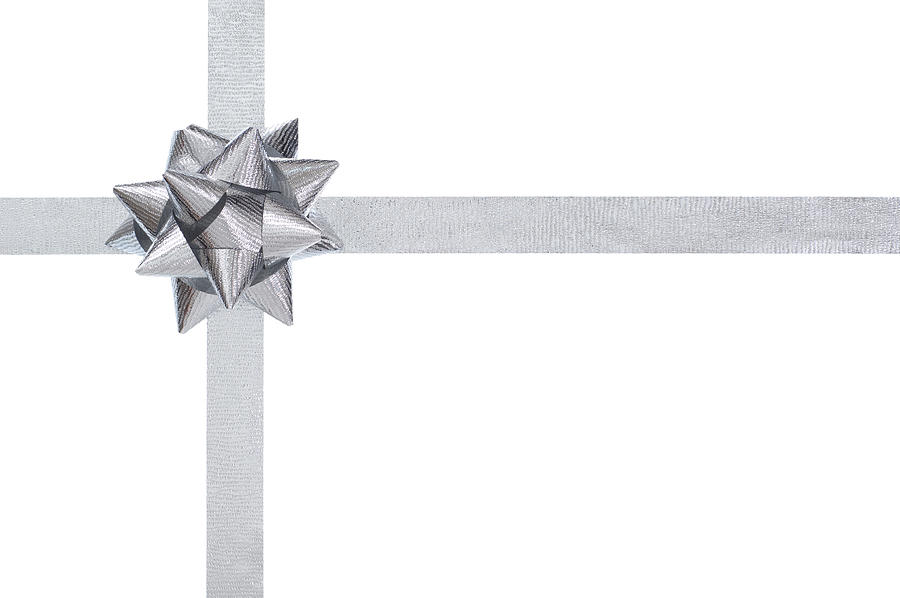 Silver present bow and ribbon, isolated on white Photograph by Stockcam