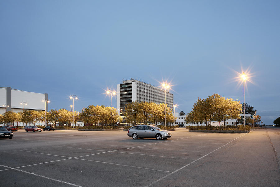 Single car in parking at evening Photograph by Johner Images