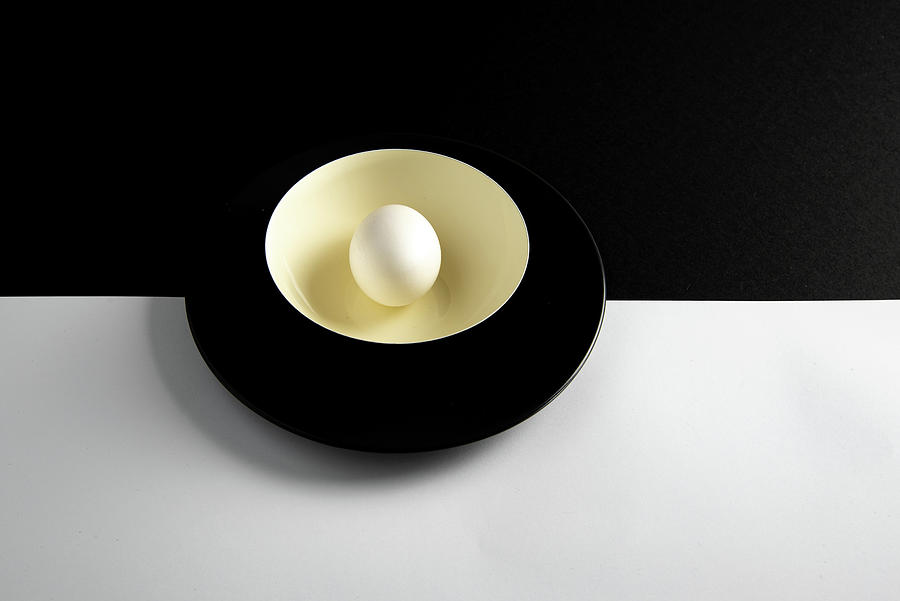 Single fresh white egg on a yellow bowl Photograph by Michalakis Ppalis