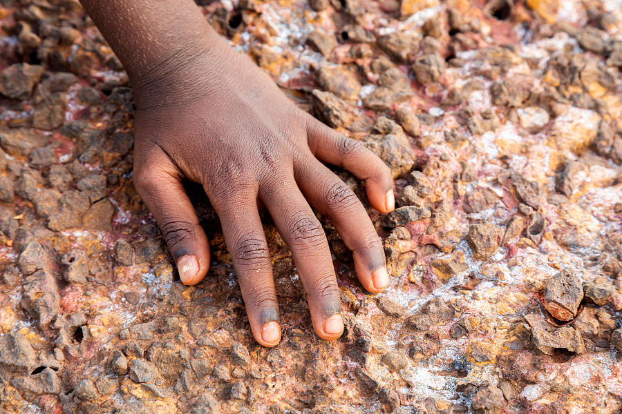 Single hand of a Young Indigenous girl on the rocks Photograph by Vicki Smith
