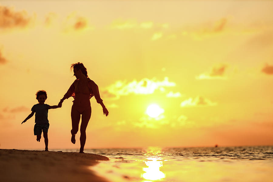 Single Mother And Son Running On The Beach Of Maldives At Sunset Photograph By Kristian Sekulic 6597