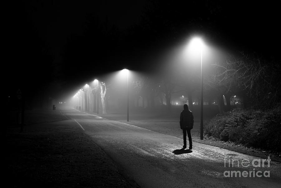 Single Person Walking on Illuminated Street in the Dark Night Photograph by Andreas Berthold