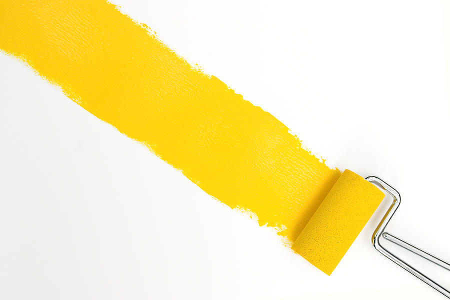 Single streak of yellow paint with rollers over white Photograph by NickS