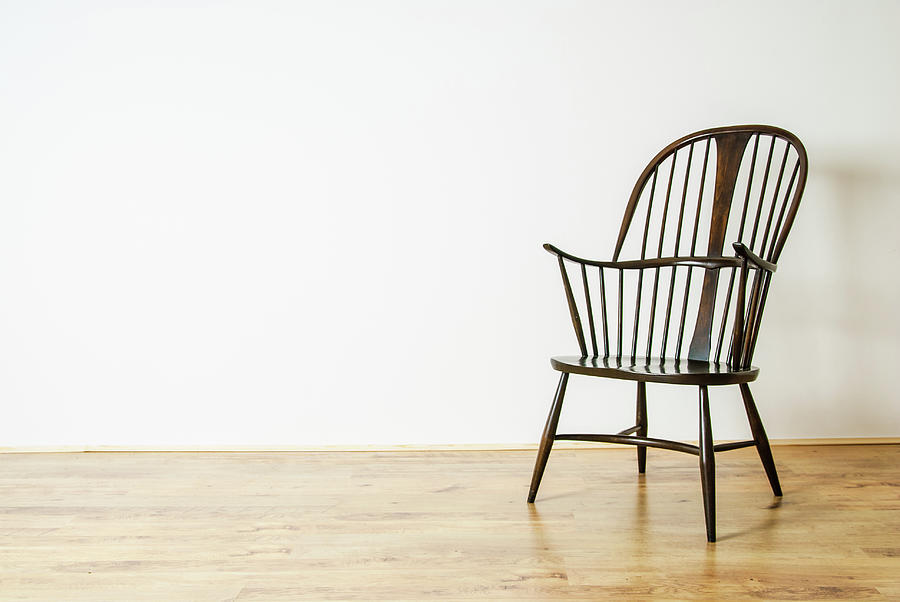 Vintage Photograph - Single Windsor style chair in empty room by David Ridley