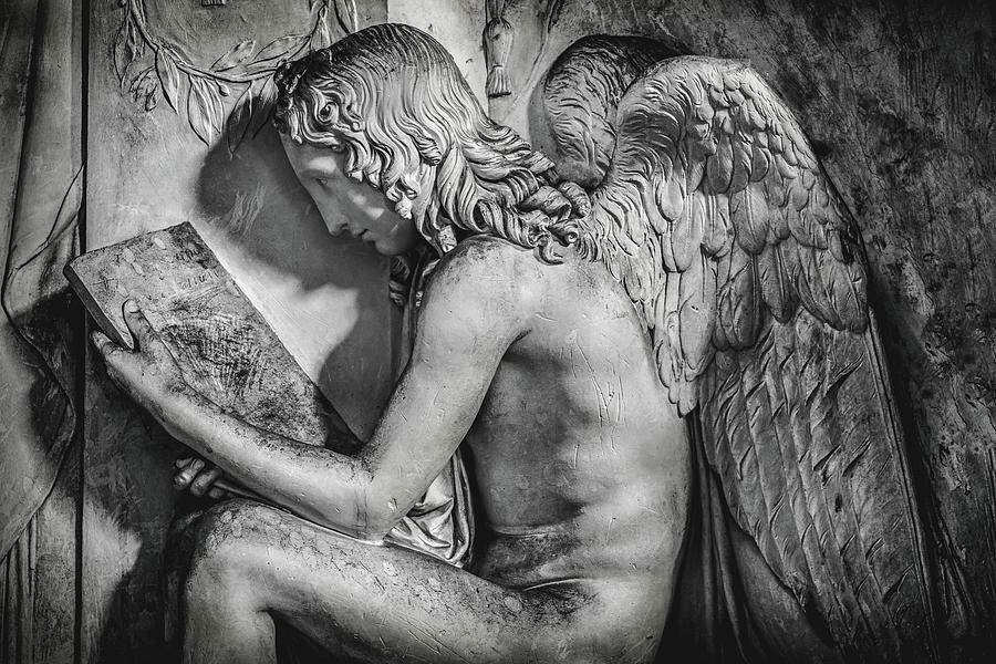 Black And White Photograph - Sitting Angel Reading Stone Tablet In Black And White Background by Luca Lorenzelli