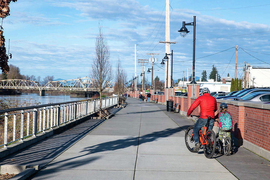Skagit Riverwalk and Two Cyclists Photograph by Tom Cochran