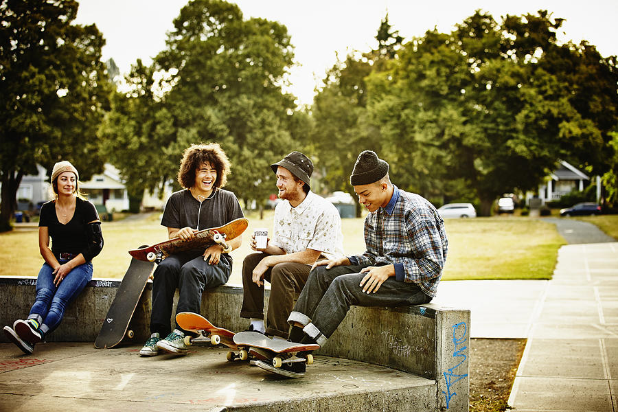 Skateboarders hanging out in skate park Photograph by Thomas Barwick
