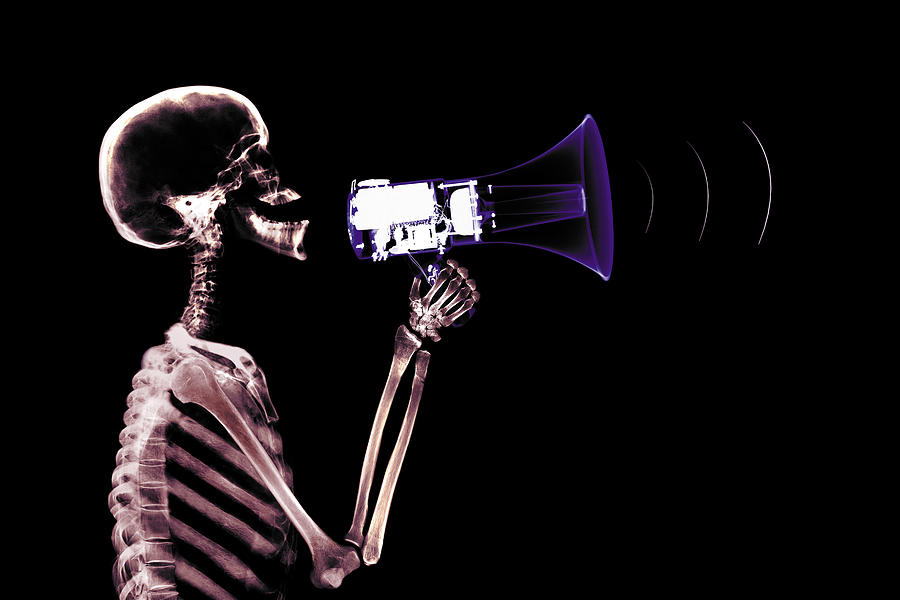 Skeleton using megaphone Photograph by Digital Vision.