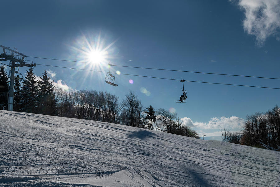 Ski lift with sunburst on winter day Photograph by Dan Friend