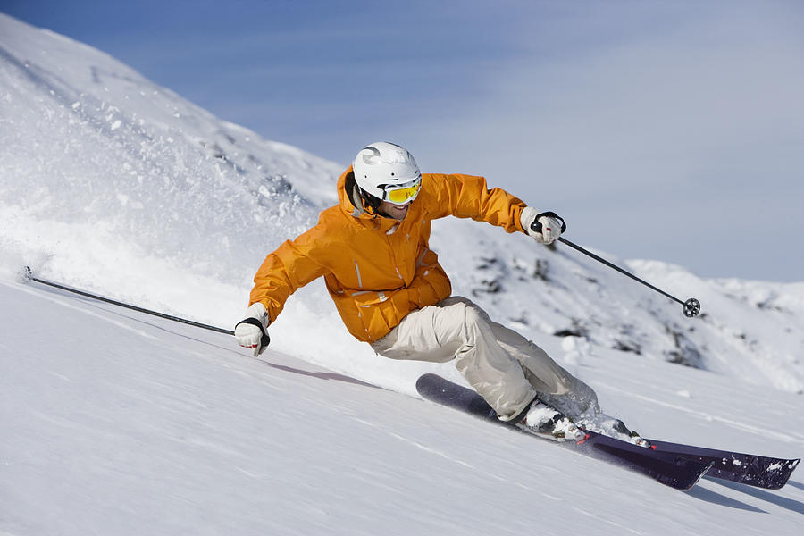 Skier carving through powder snow Photograph by Adie Bush
