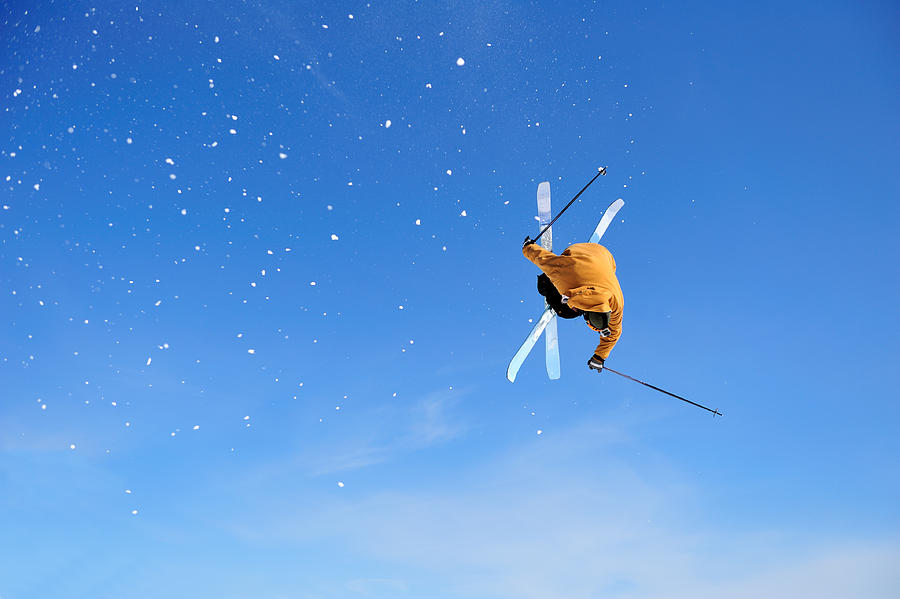 Skier Iron Cross stunt against blue sky Photograph by Davidkl
