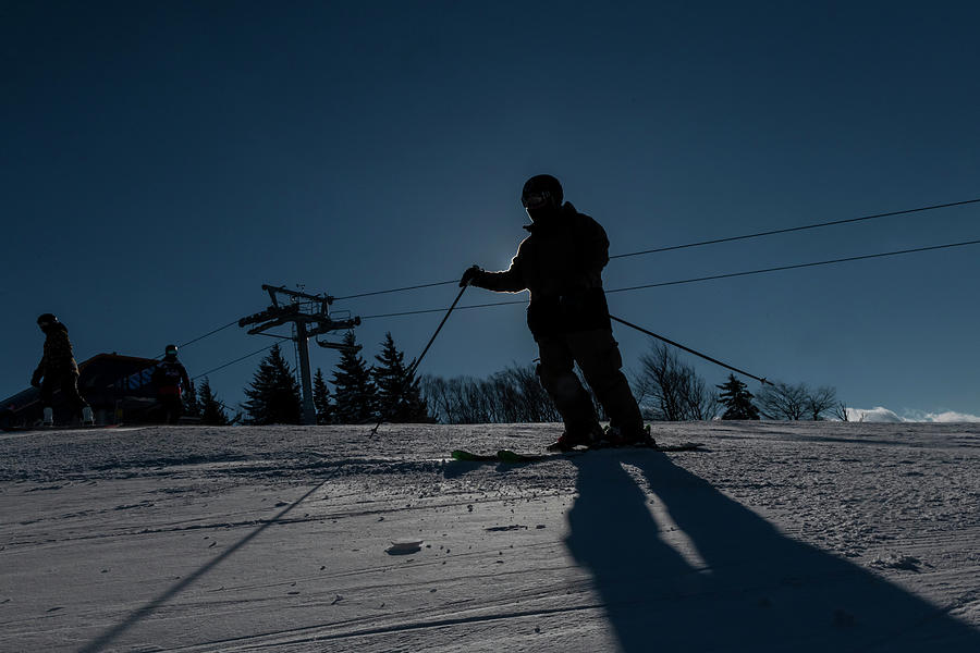 Skier on slope in silhouette Photograph by Dan Friend
