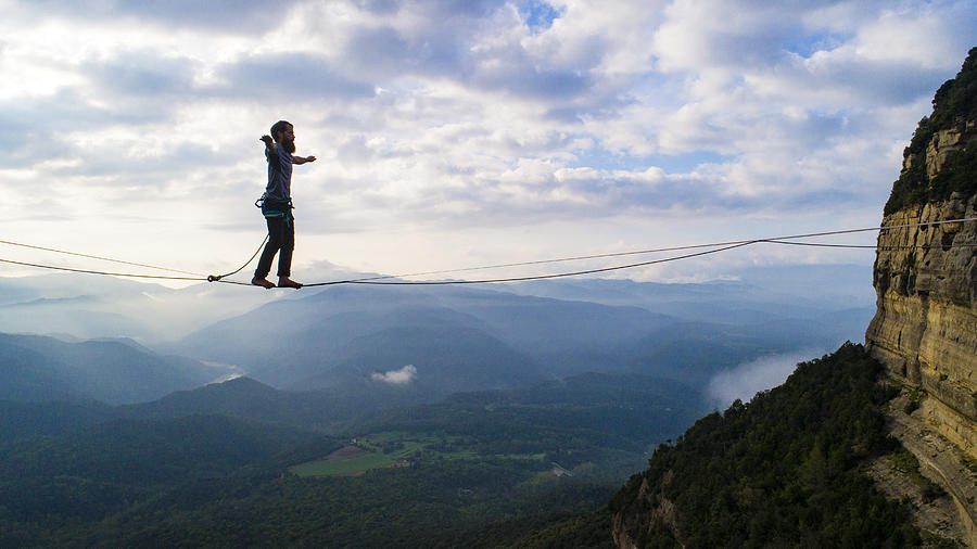 Slacklining in the mountains Photograph by Aluxum