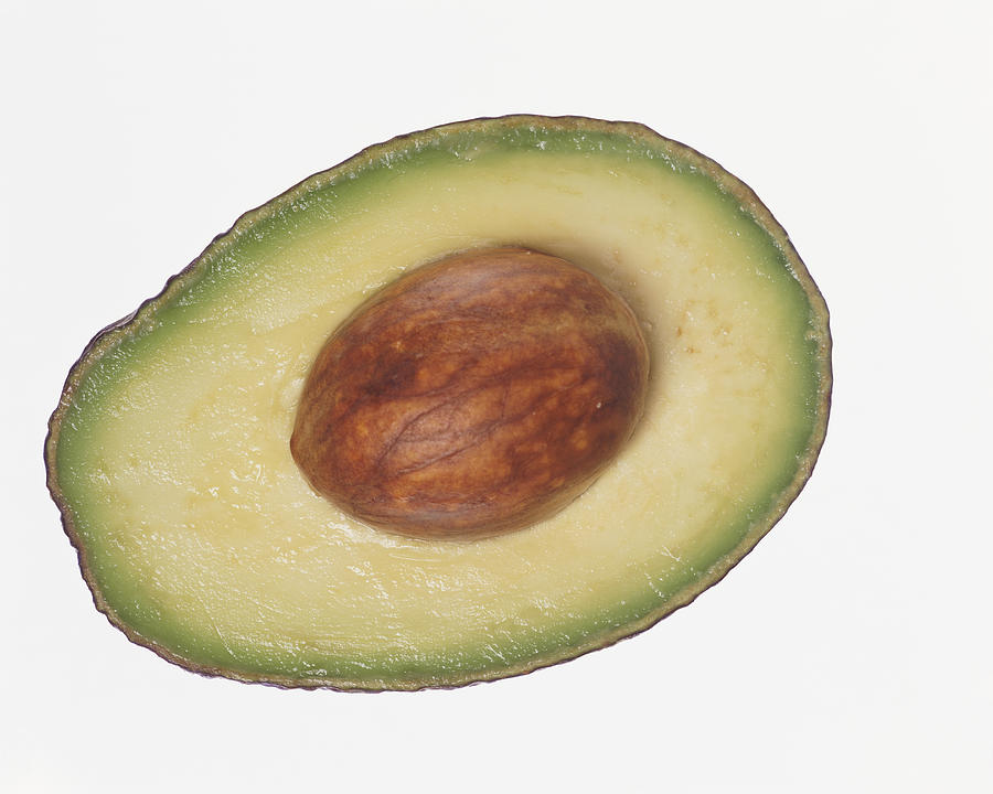 Slice of Avocado Containing a Seed Photograph by Digital Vision.