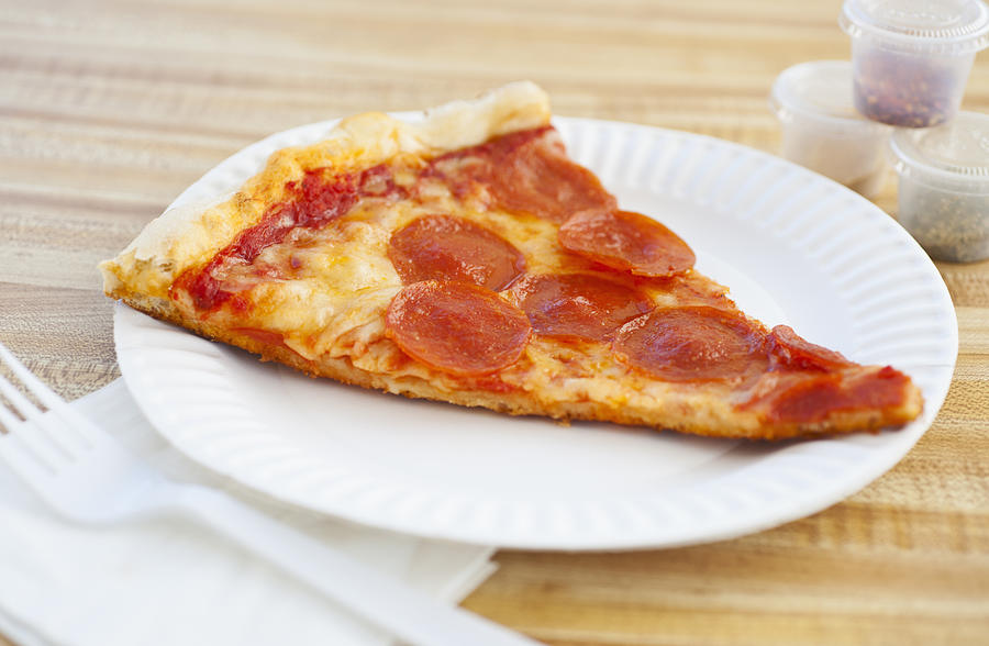 Slice of pepperoni pizza on plate Photograph by Tetra Images