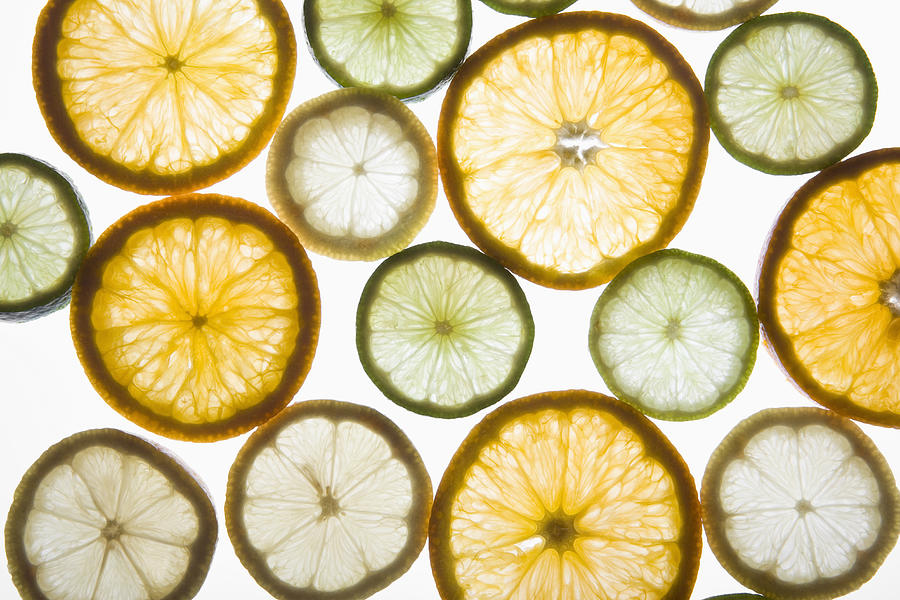 Sliced citrus fruits on a lightbox Photograph by Halfdark