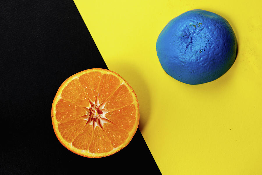 Slices fresh citrus orange fruit on a black and yellow background. Photograph by Michalakis Ppalis