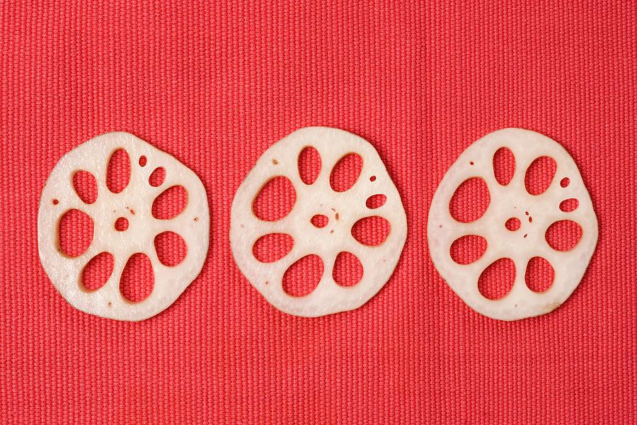 Slices of lotus root Photograph by Image Source
