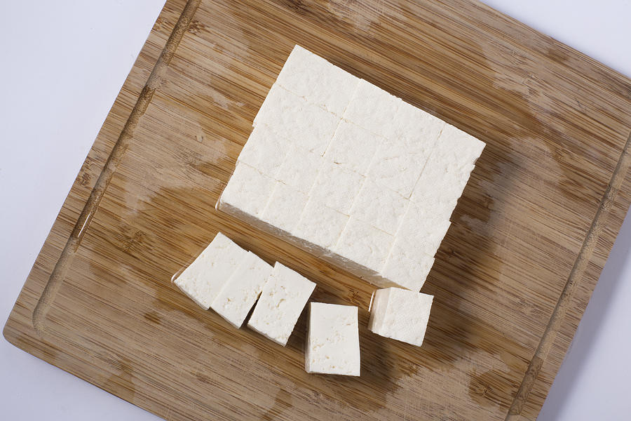 Slices of raw tofu on cutting board Photograph by Bong Hyunjung
