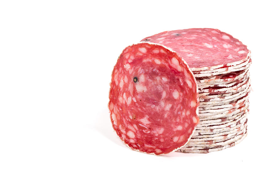 Slices of salami sausages isolated on a white background Photograph by R.Tsubin
