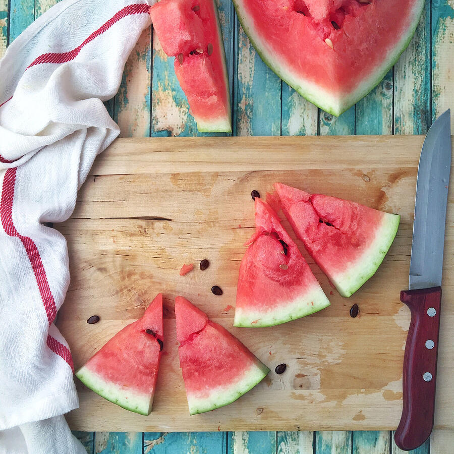 Slices of watermelon on a chopping board Photograph by Ahaddini_maretty