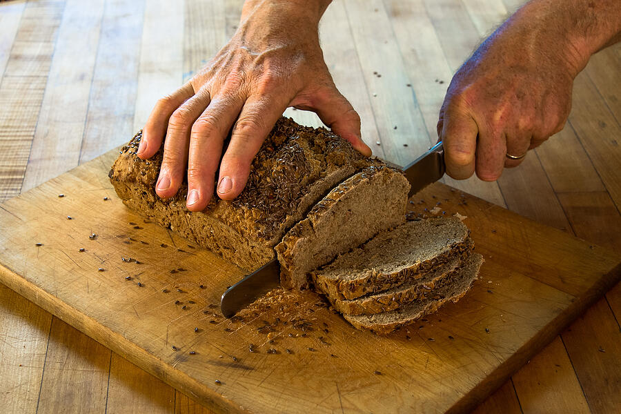 Slicing Fresh Whole Wheat Beer Bread Photograph by Chris Minerva