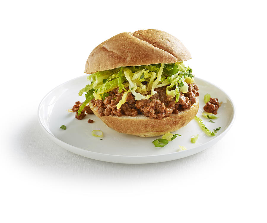 Sloppy joe with lettuce on white plate on white Photograph by Annabelle Breakey
