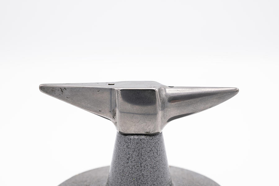 Small anvil in front of white background Photograph by Stefan
