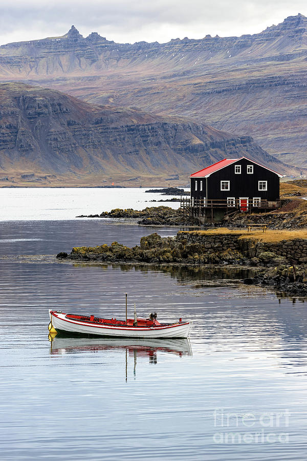 Small boat and black wooden house, Djupivogur, Eastfjords, Icela Photograph by Jane Rix
