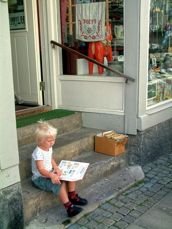Small boy reading on pavement Painting by Sam Hall
