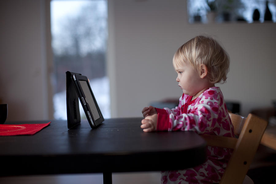 Small child wathing movie on digital tablet Photograph by Anders Andersson