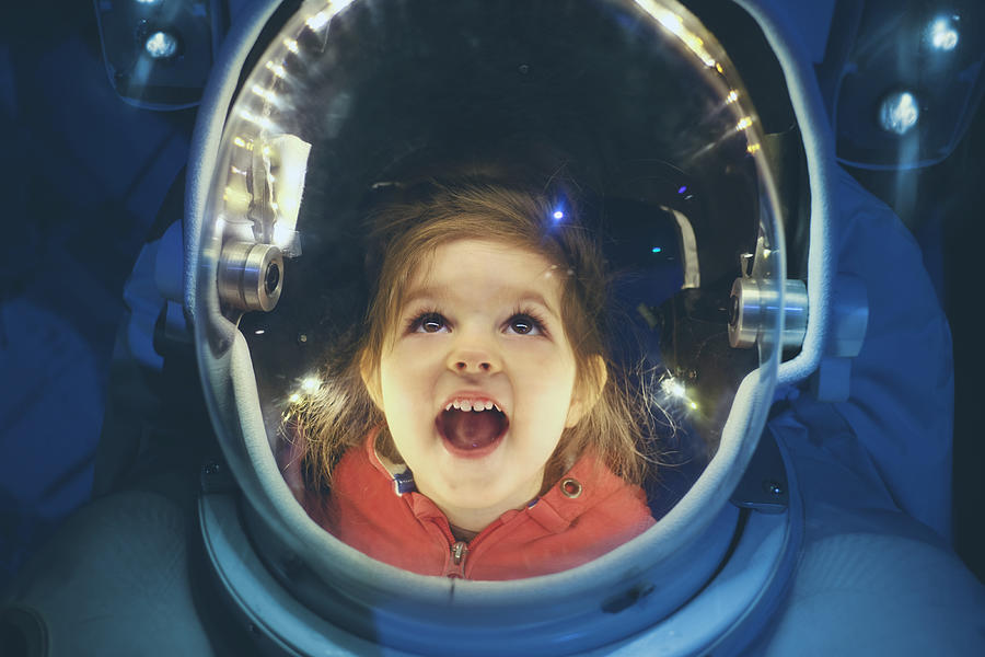 Small girl enjoying being inside of astronaut suit Photograph by Stanislaw Pytel
