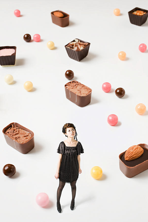 Small woman and big candy Photograph by Image Source
