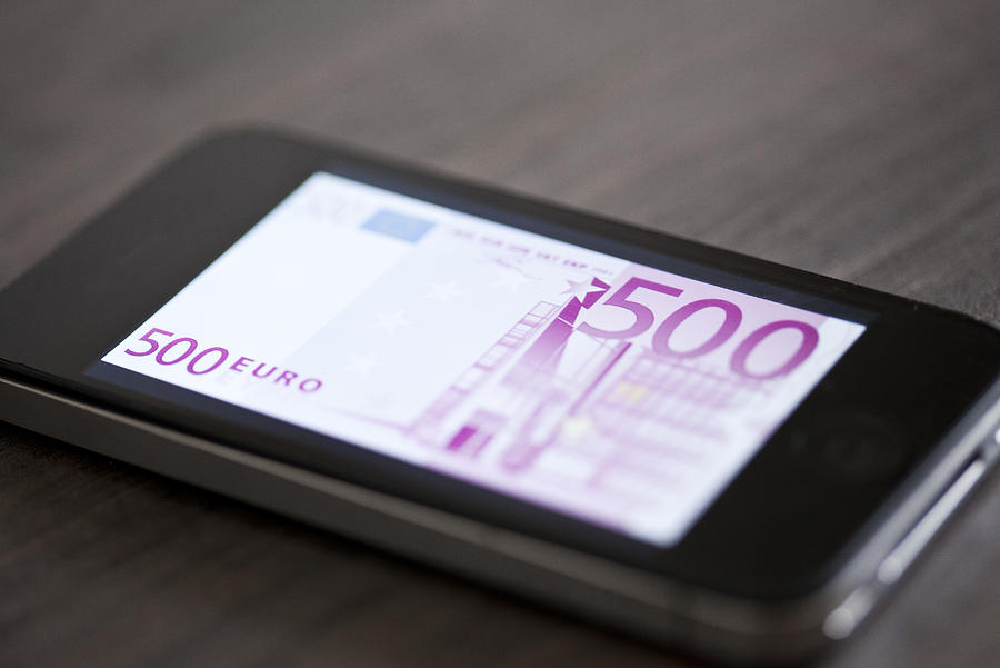 Smartphone displaying image of five-hundred euro banknote Photograph by PhotoAlto/Gabriel Sanchez