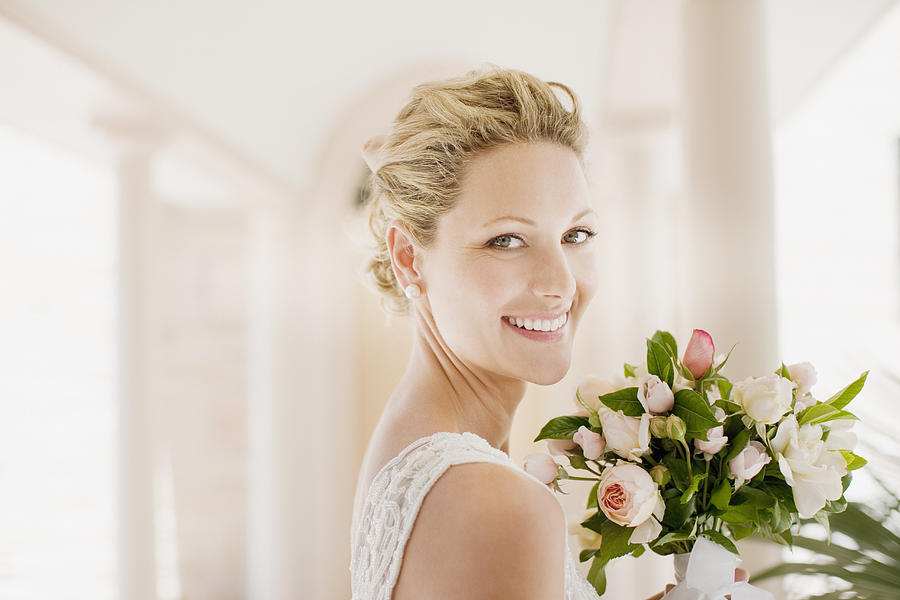 Smiling bride with bouquet Photograph by Tom Merton