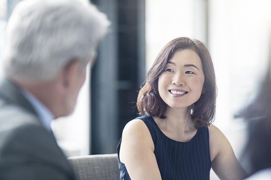 Smiling businesswoman looking at mature coworker Photograph by Xavierarnau