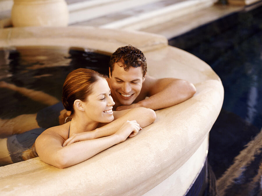 Smiling Couple Relaxing in a Bathhouse Photograph by Flying Colours Ltd