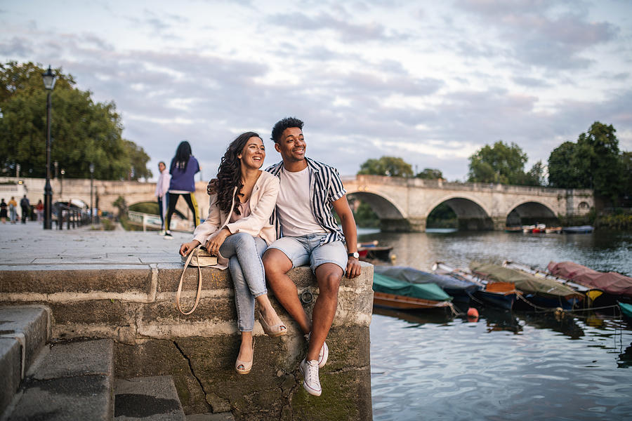 Smiling Couple Sitting on Embankment in Richmond Upon Thames Photograph by AzmanJaka
