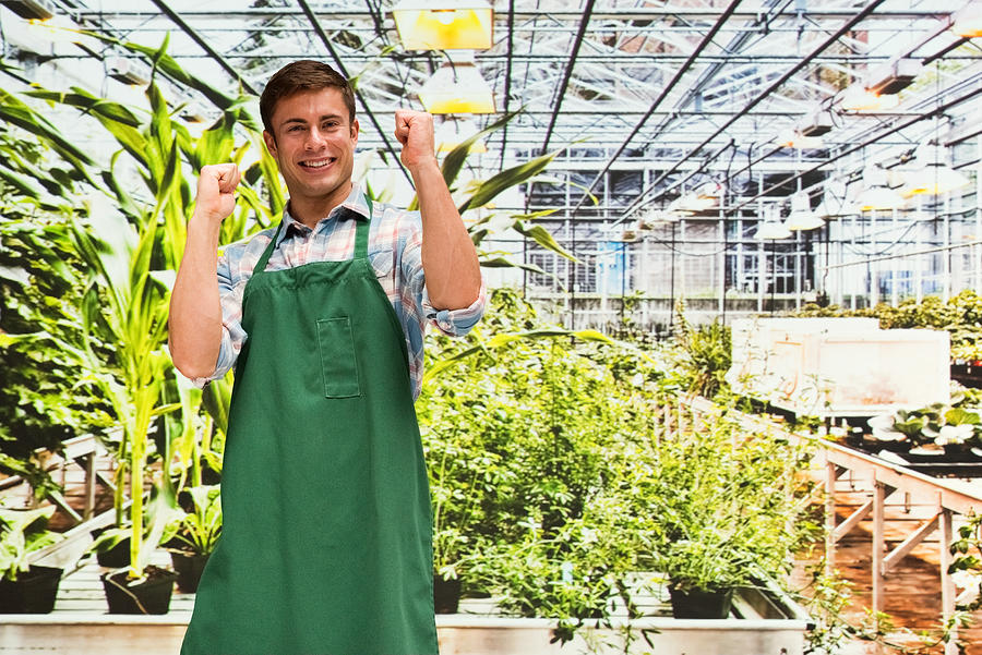 Smiling florist cheering in greenhouse Photograph by 4x6