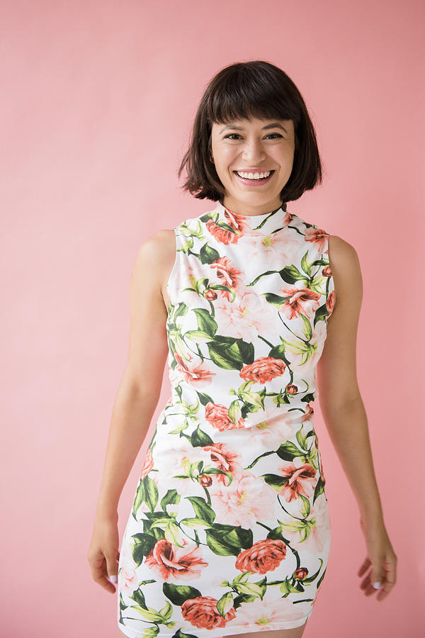 Smiling Hispanic woman wearing floral dress Photograph by JGI/Jamie Grill