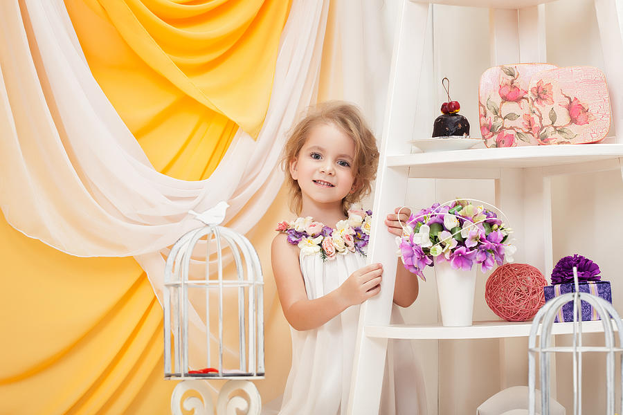 Smiling little girl posing in decorated studio Photograph by Wisky