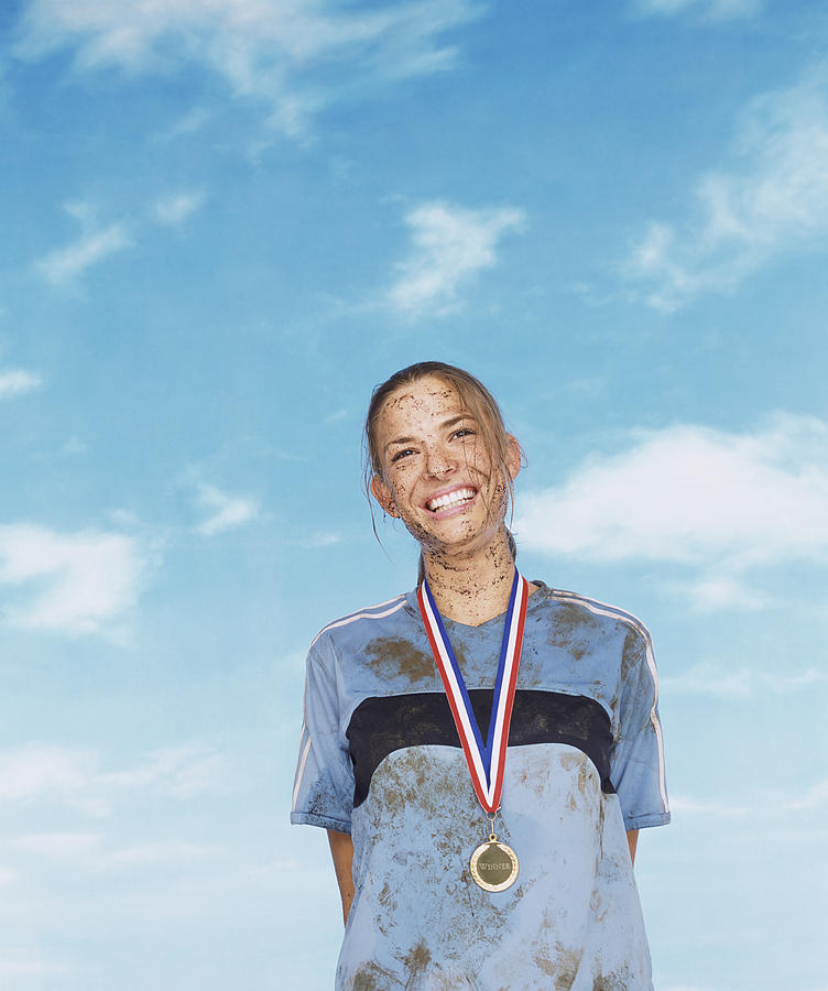 Smiling Mud Splattered Sportswoman Wearing a Gold Medal Photograph by John Slater