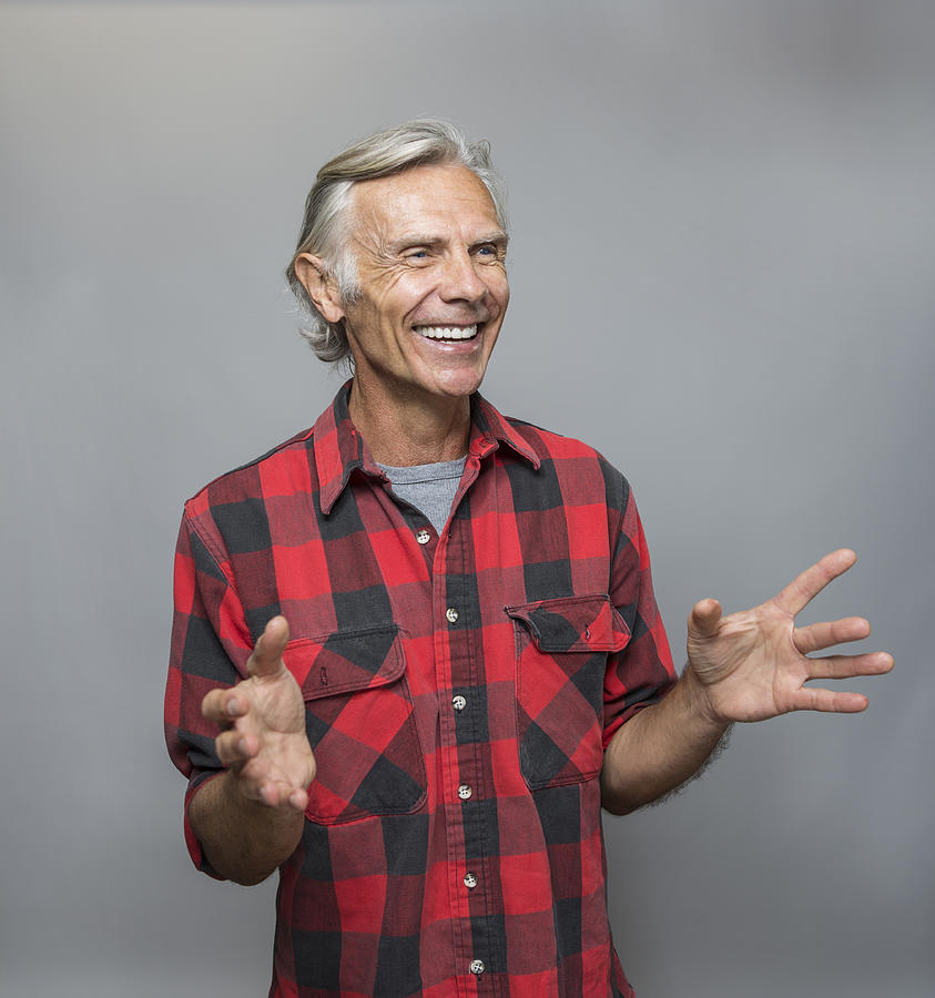 Smiling older Caucasian man gesturing Photograph by Sam Diephuis