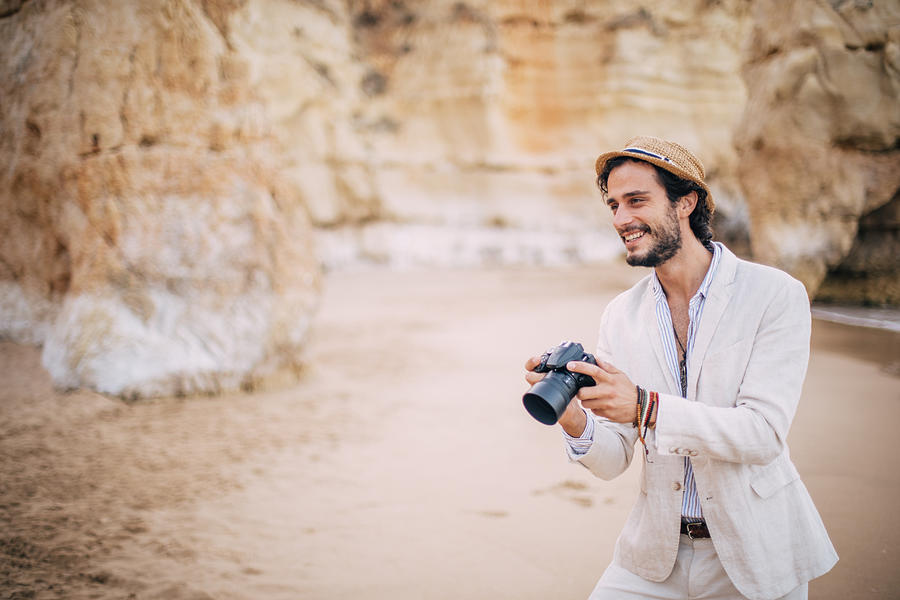 Smiling Photographer at the beach Photograph by South_agency