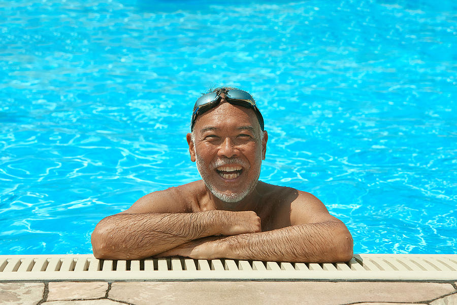 Smiling Senior Man on the rooftop pool Photograph by Yoshiyoshi Hirokawa
