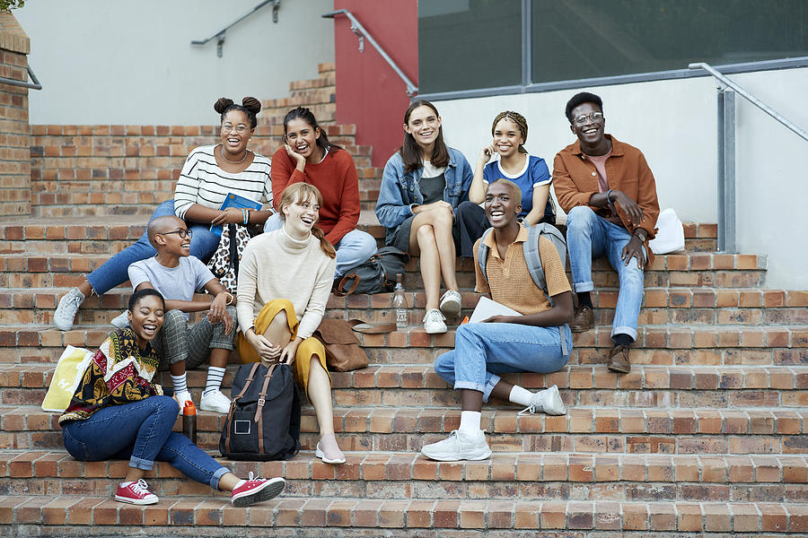 Smiling young university students sitting on steps Photograph by Klaus Vedfelt