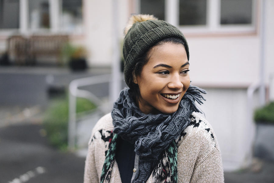 Smiling young woman wearing wooly hat outdoors Photograph by Westend61