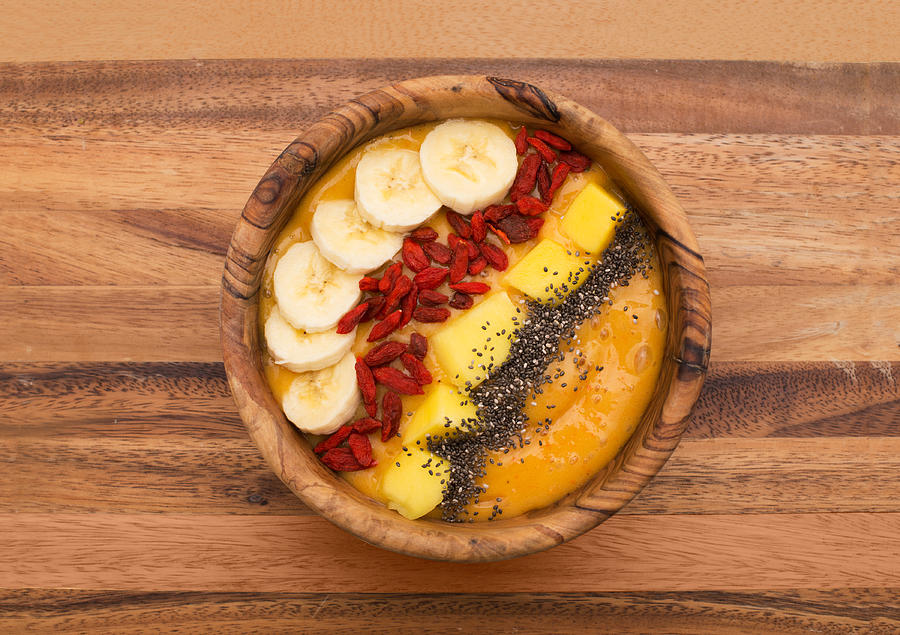 Smoothie Bowl Topped With Goji, Banana, Mango And Chia Seeds Photograph by MarisaLia
